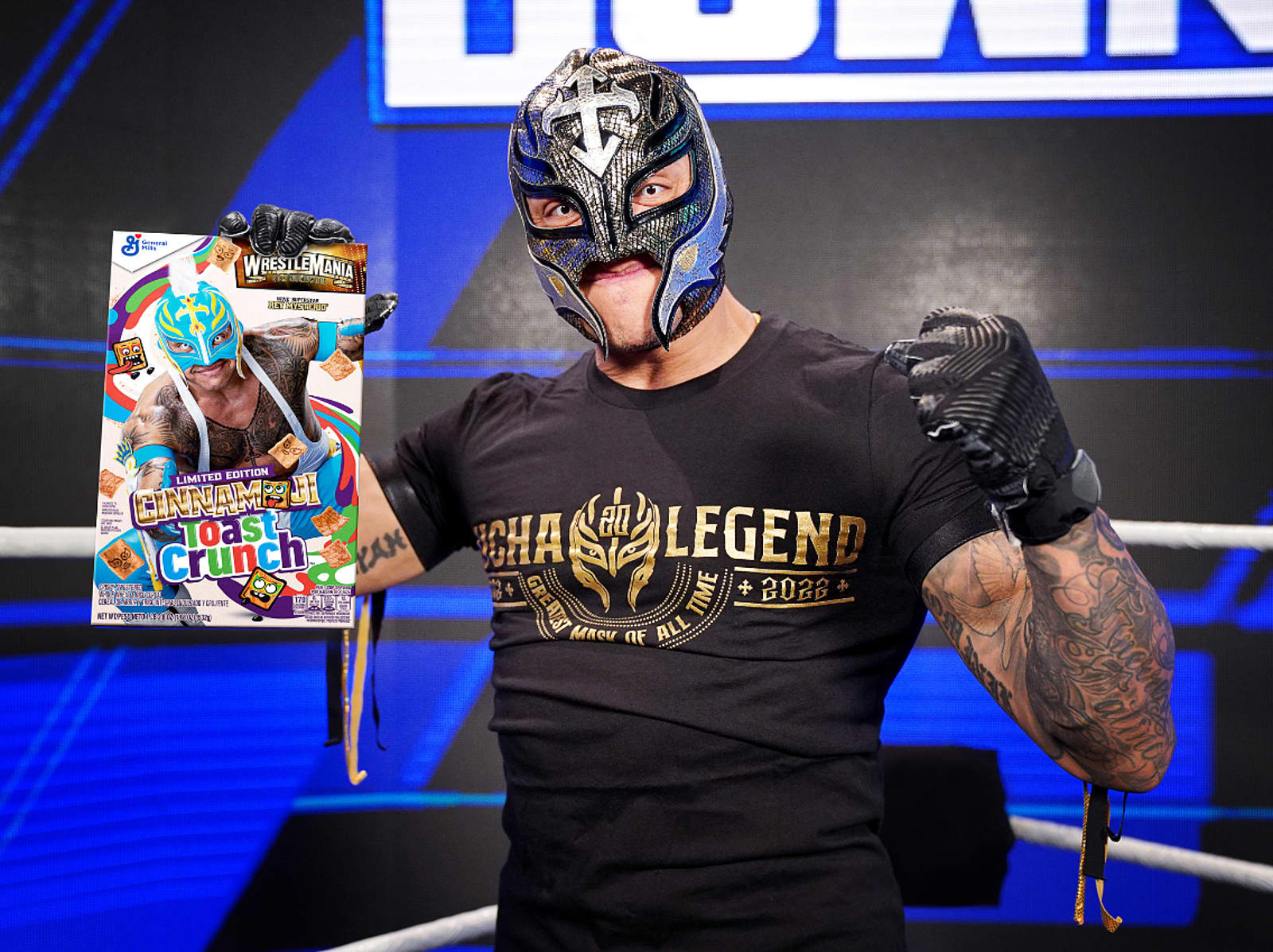 Rey Mysterio holding box of Cinnamon Toast Crunch with his fist in the air